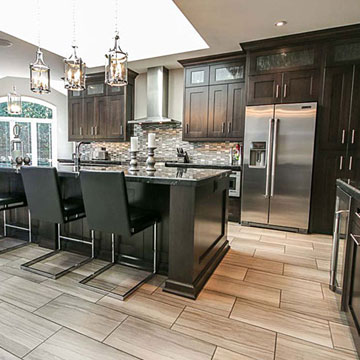 Dark wood cabinets in large kitchen with island