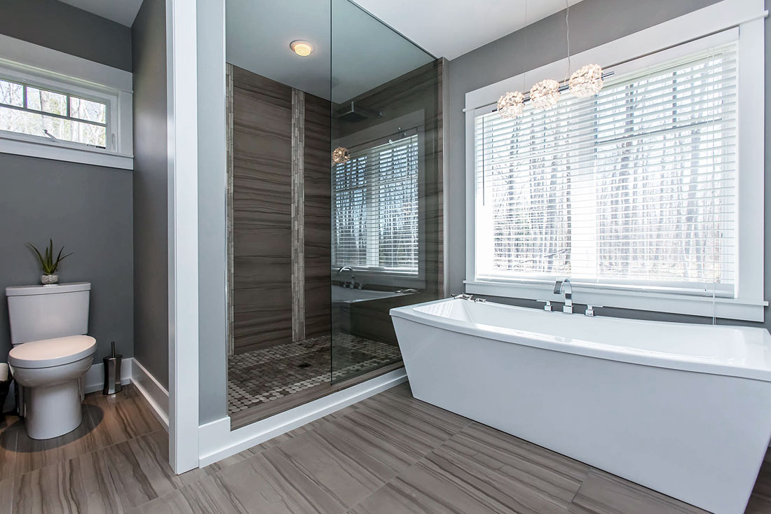 Wiltshire bathroom with glass shower and soaker tub.