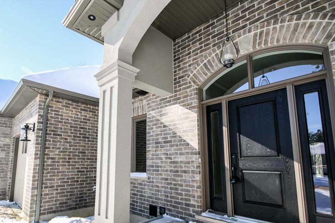 Yorkshire exterior with view of 3 car garage.